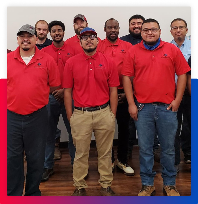 employees standing facing the camera for a group photo
